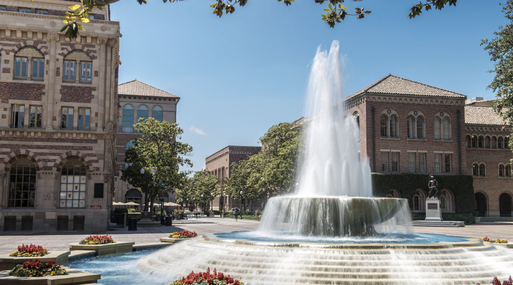 Image of fountain from Hahn Plaza in foreground with the Student Union and Bovard buildings in the backgound.